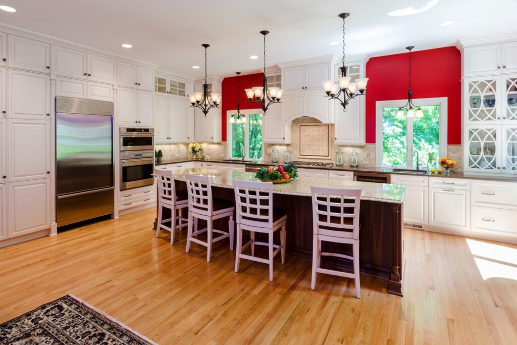 Luxury kitchen remodel featuring a 10-foot walnut island with granite countertops and white perimeter cabinetry
