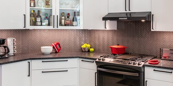 Custom painted David Bradley cabinetry with a durable high-gloss finish paired with velvety matte countertops in a functional kitchen remodel.